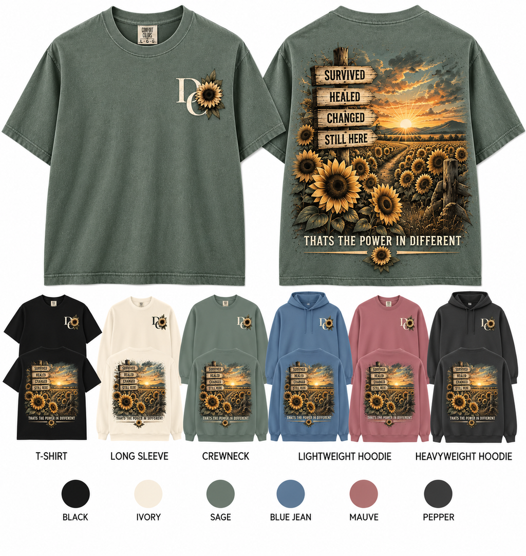 Different Cloth Co. Comfort Colors apparel featuring a scenic road, sunrise and sunflowers with Survived Healed changed Still Here signs and matching chest design
