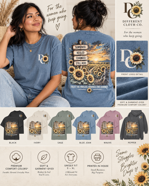 Different Cloth Co. Survived Healed Changed Still Here lifestyle image featuring a woman modeling the Blue Jean Comfort Colors shirt with sunflower sunrise artwork, front logo detail, garment options and colors.
