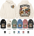Different Cloth Co. Recovery Proof That the Story Continued apparel featuring floral skull, sunrise and mountain artwork with front chest design, shown in available garment colors and styles.