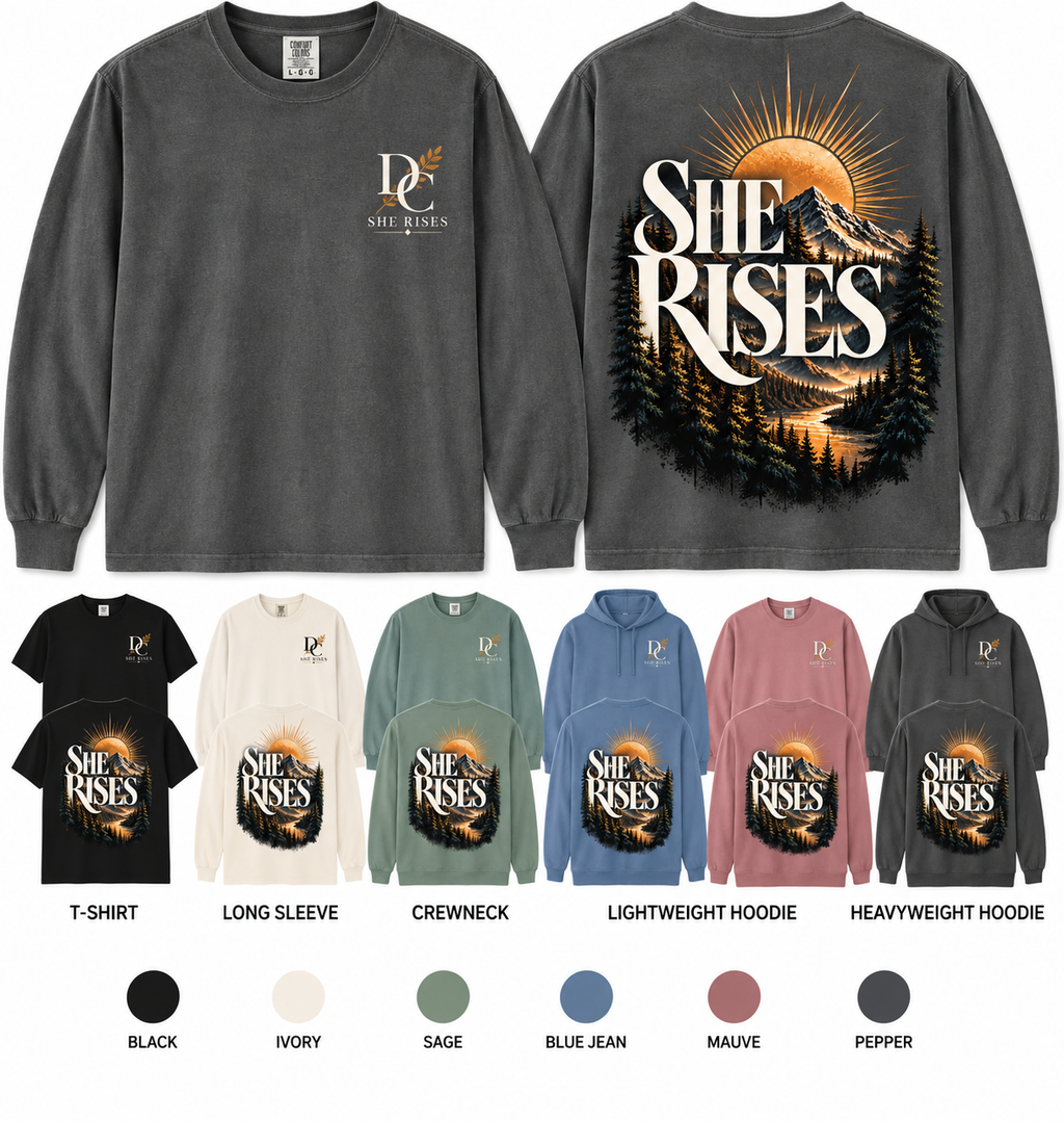 She Rises Comfort Colors apparel by Different Cloth Co. featuring a mountain sunrise graphic with front chest and full back design.