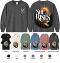 She Rises Comfort Colors apparel by Different Cloth Co. featuring a mountain sunrise graphic with front chest and full back design.