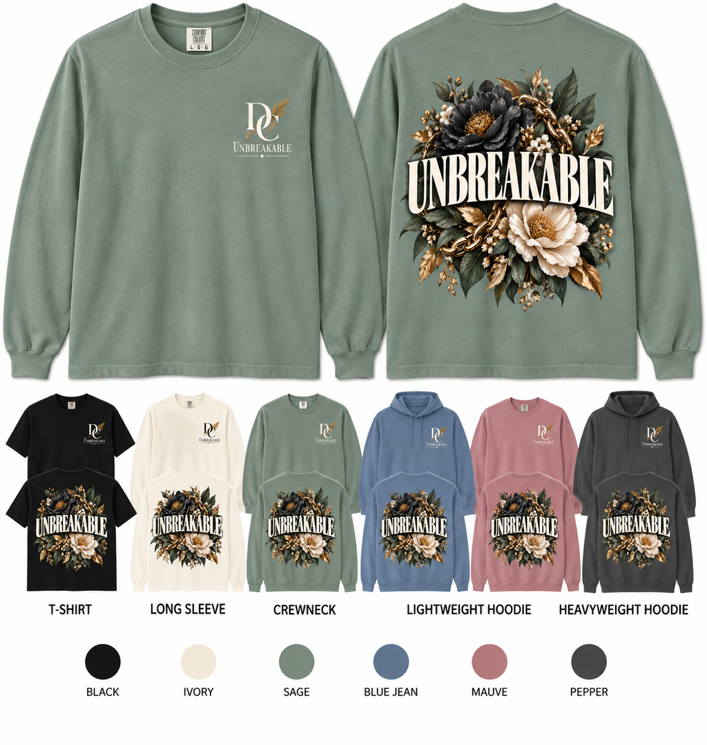 Unbreakable Built to Bloom Comfort Colors apparel by Different Cloth Co. featuring bold Unbreakable lettering with layered floral and botanical artwork.